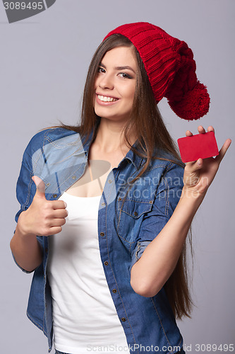 Image of Smiling woman holding credit card