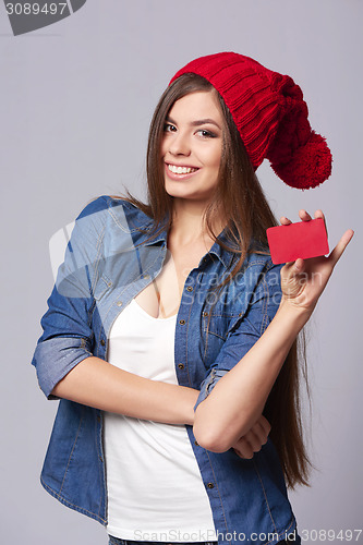 Image of Smiling woman holding credit card