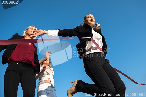 Image of business people running on racing track