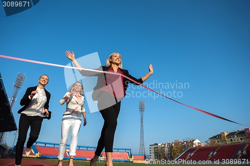 Image of business people running on racing track