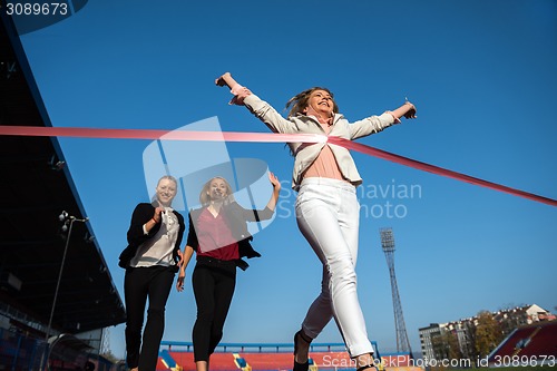 Image of business people running on racing track