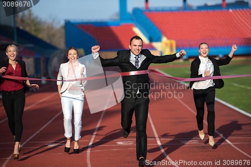 Image of business people running on racing track