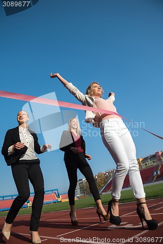 Image of business people running on racing track