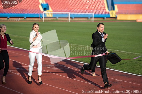 Image of business people running on racing track