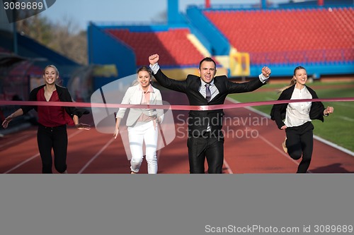 Image of business people running on racing track