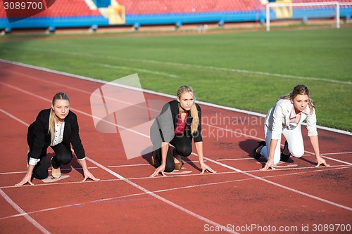 Image of business people running on racing track