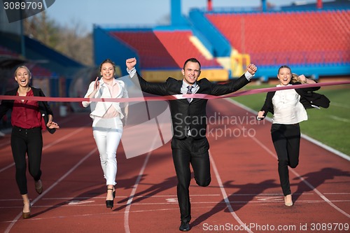 Image of business people running on racing track