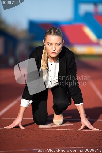 Image of business woman ready to sprint