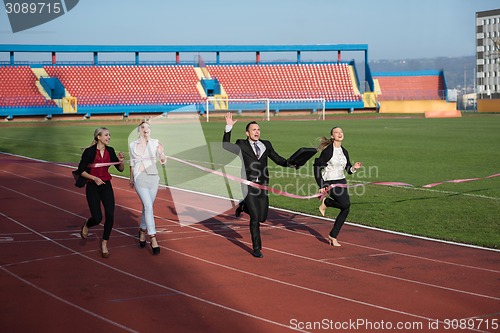 Image of business people running on racing track