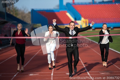 Image of business people running on racing track