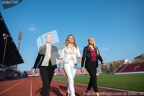 Image of business people running on racing track