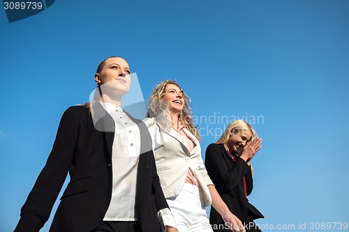 Image of business people running on racing track