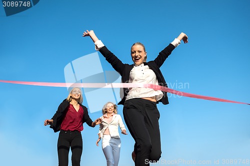 Image of business people running on racing track