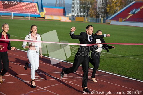 Image of business people running on racing track