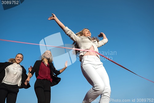 Image of business people running on racing track