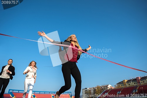 Image of business people running on racing track