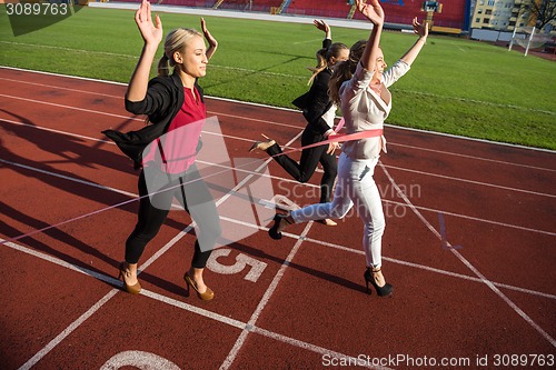 Image of business people running on racing track