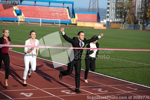 Image of business people running on racing track