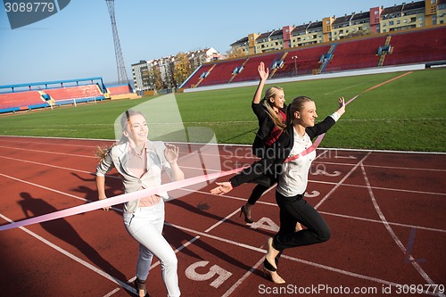 Image of business people running on racing track