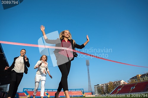 Image of business people running on racing track