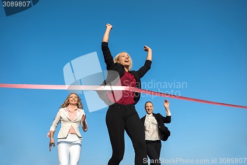 Image of business people running on racing track