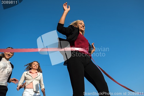 Image of business people running on racing track