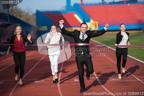 Image of business people running on racing track