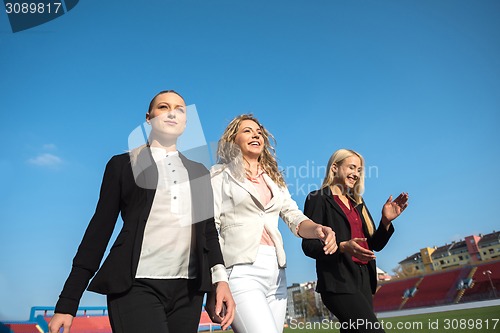 Image of business people running on racing track