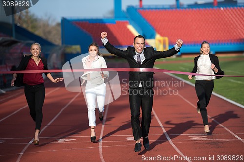 Image of business people running on racing track