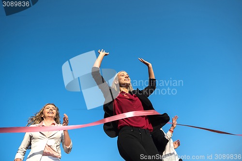 Image of business people running on racing track