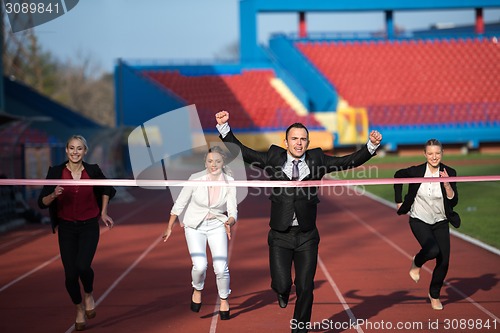 Image of business people running on racing track