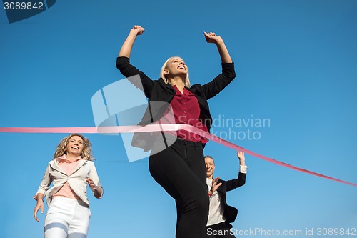 Image of business people running on racing track