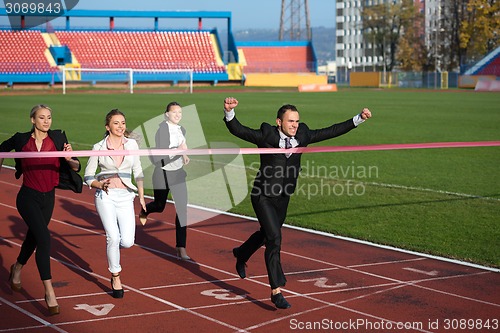 Image of business people running on racing track