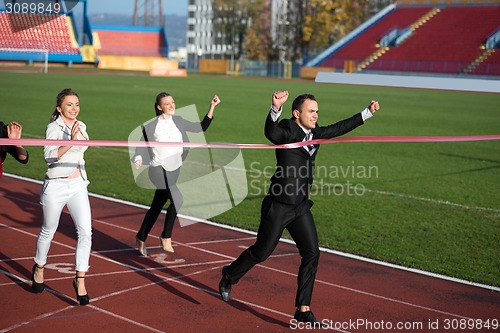 Image of business people running on racing track