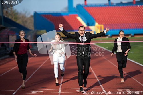 Image of business people running on racing track