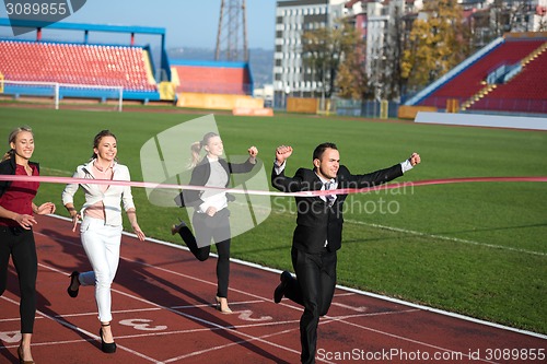 Image of business people running on racing track