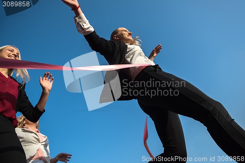 Image of business people running on racing track