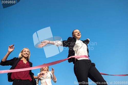 Image of business people running on racing track