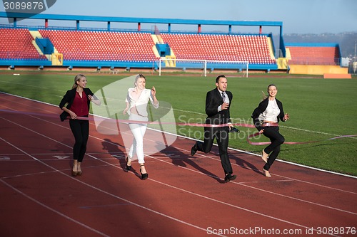 Image of business people running on racing track