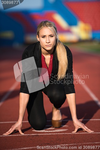 Image of business woman ready to sprint