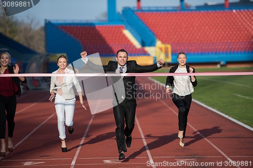 Image of business people running on racing track