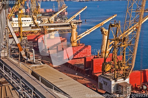 Image of Grain from silos being loaded onto cargo ship on conveyor belt