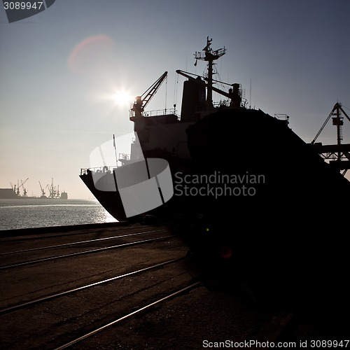 Image of Grain from silos being loaded onto cargo ship on conveyor belt