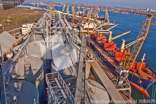 Image of Grain from silos being loaded onto cargo ship on conveyor belt