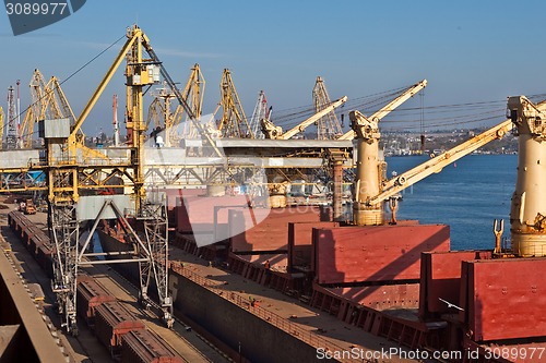 Image of Grain from silos being loaded onto cargo ship on conveyor belt