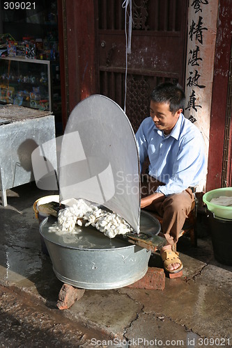 Image of Man producing silk in China