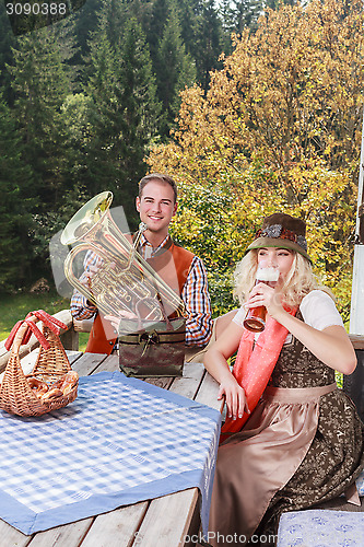 Image of Young couple in traditional Bavarian clothes enjoy your leisure in common