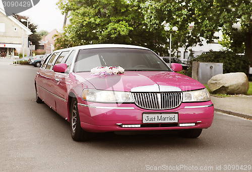 Image of pink wedding limousine