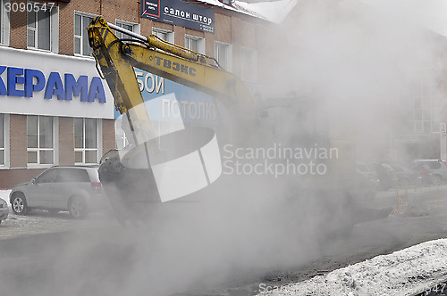 Image of the excavator digs out break on a heating main.