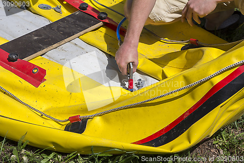 Image of Pumping rubber boat